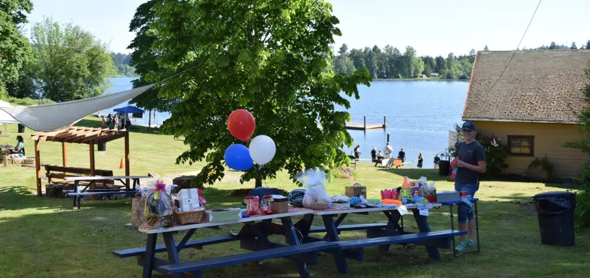 Picnic area with balloons near lake