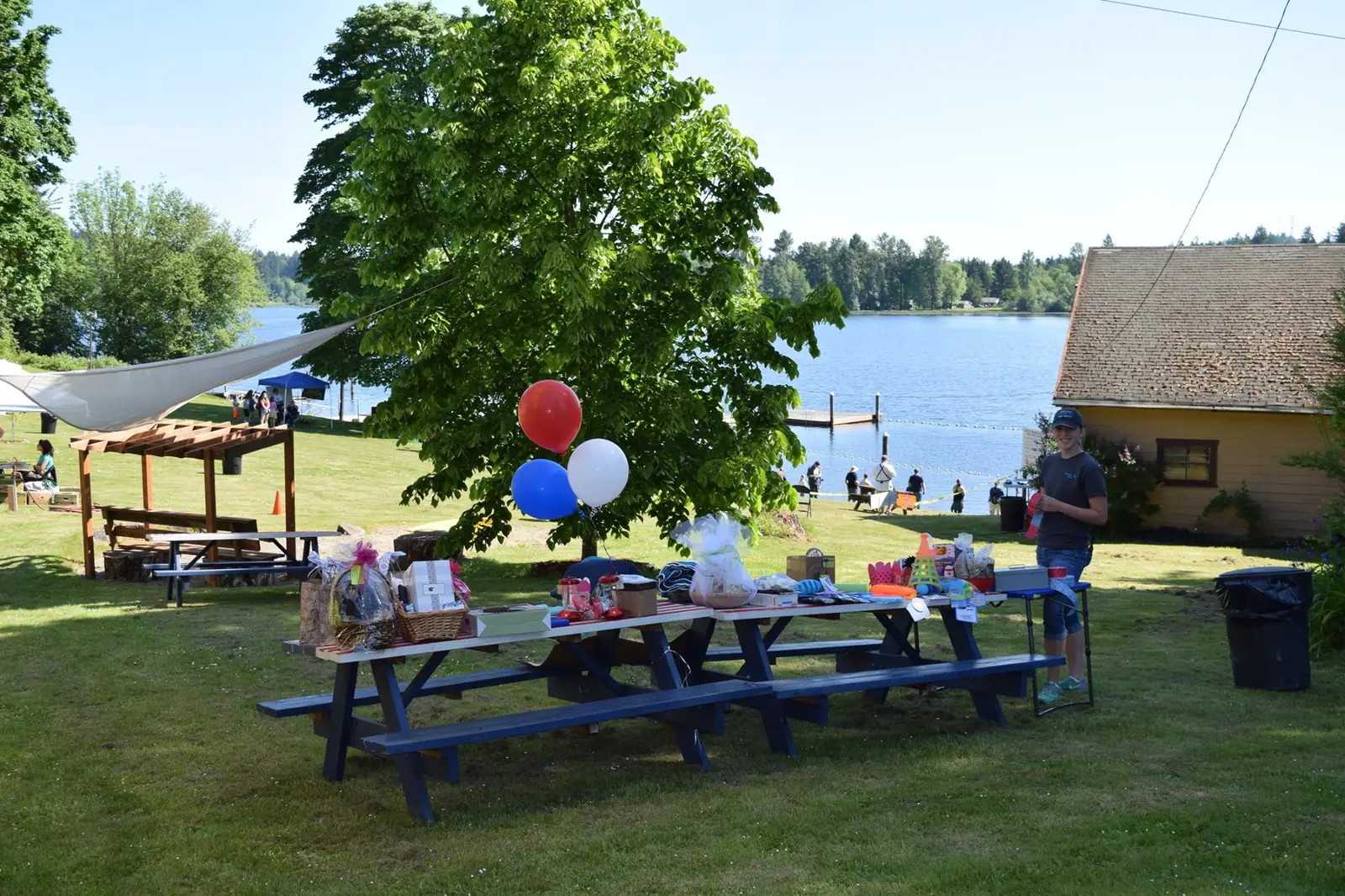 A picnic celebration with balloons and a decorated table overlooking Black Lake