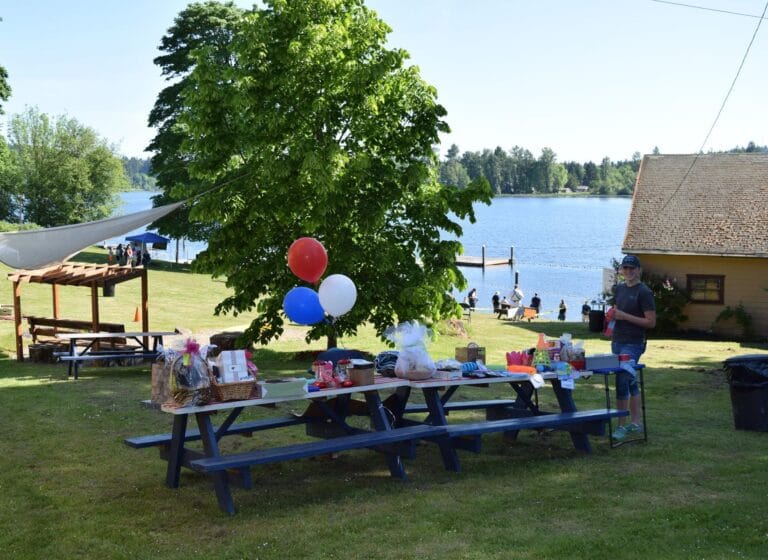 Picnic area with balloons near lake